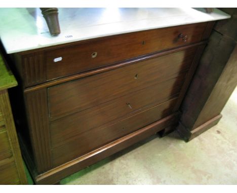 A 19th century continental mahogany commode/washstand of four long drawers flanked by fluted mouldings beneath a white and gr
