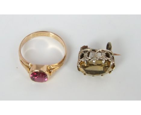 A small Victorian/Edwardian citrine pin/brooch in unmarked white and yellow metal together with a 15c gold ring collette set 