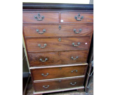 A Georgian mahogany chest on chest of five long and two short drawers, the cast brass handles and escutcheon beneath a dentil