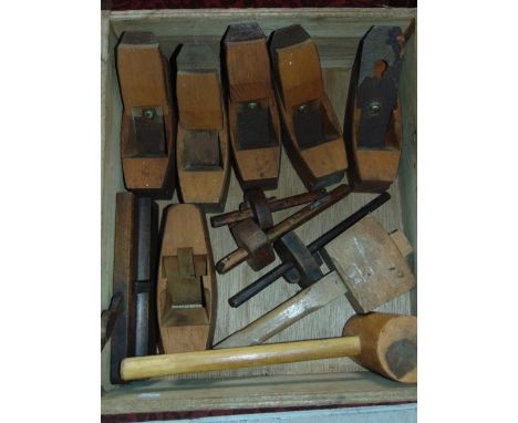 A collection of vintage beechwood planes, gauges and mallets