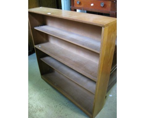 A light oak floor standing open bookcase with fixed shelves 
