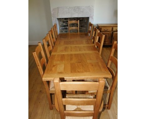 A Wesley Barrel rustic oak drawer leaf extending table with panelled top raised on four chamfered supports together with 10 (