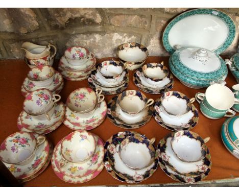 A collection of Ainsley tea wares with printed floral decoration comprising a milk jug, sugar bowl, eight cups, eight saucers