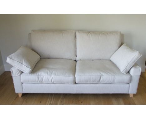 A Wesley Barrell Burleigh high back three and a half seater sofa in a Ian Sanderson Phoenix oatmeal coloured fabric on a natu