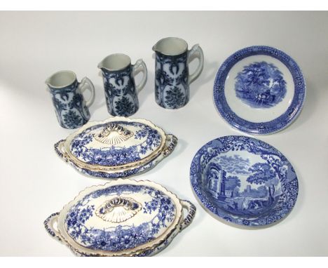 A collection of blue and white printed ceramics including a set of three graduated Britannia pottery jugs with floral decorat
