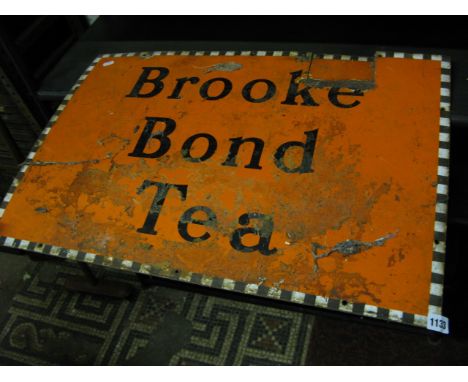 A vintage enamel sign of rectangualr form advertising Brooke Bond Tea, with orange ground and black lettering within a cheque