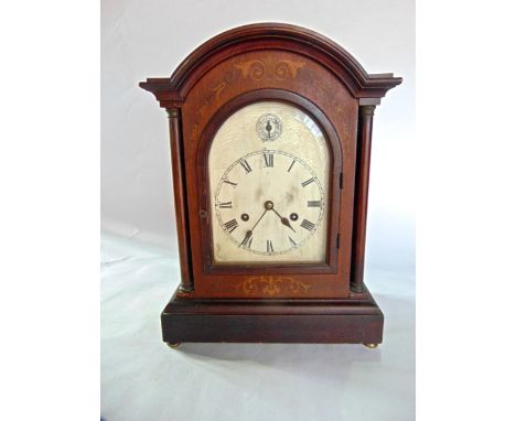 An Edwardian mahogany bracket clock, the arched and silver dial with silent chime selector, the eight day movement striking o