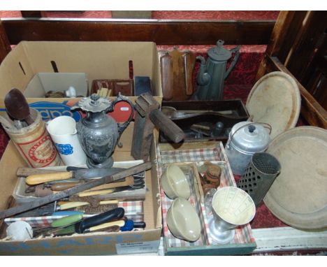 A large collection of vintage kitchenalia including cutlery boxes, wooden spoons, bread and other knives, bread boards, condi