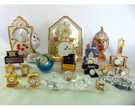 A collection of highly decorative modern mantle clocks in various cases mainly ceramic and a further collection of miniature 