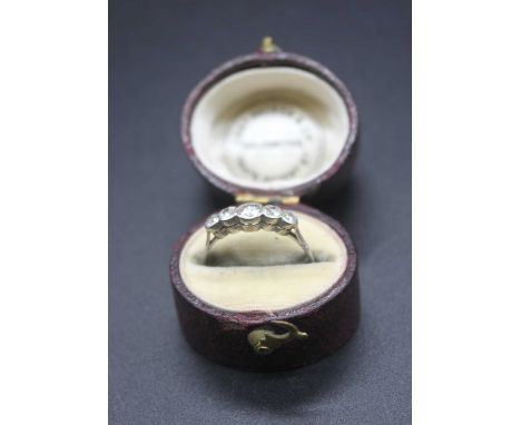 An Edwardian white metal diamond five stone ring, the old round cuts each being illusion set, the centre stone weighing appro