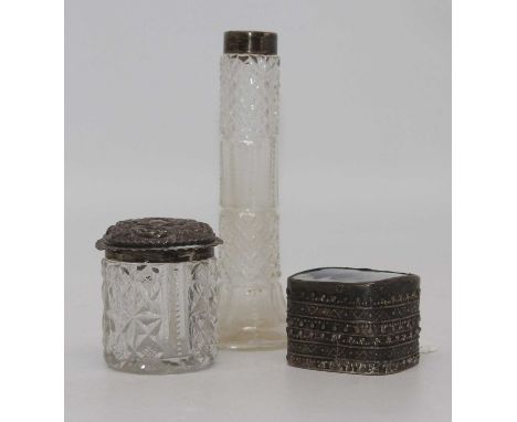 An Edwardian cut glass dressing table jar with embossed silver top, together with a silver topped cut glass specimen vase, an