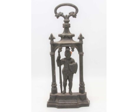 A Victorian cast iron door stop in the form of a knight under an arch, marked Coalbrookdale to the reverse