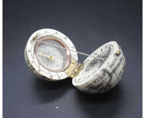 A reproduction faux ivory pocket compass in the form of a globe, dia.4.2cm