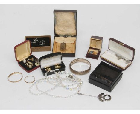 A collection of miscellaneous items to include a silver ingot pendant, engraved silver hinged bangle, white metal and paste s