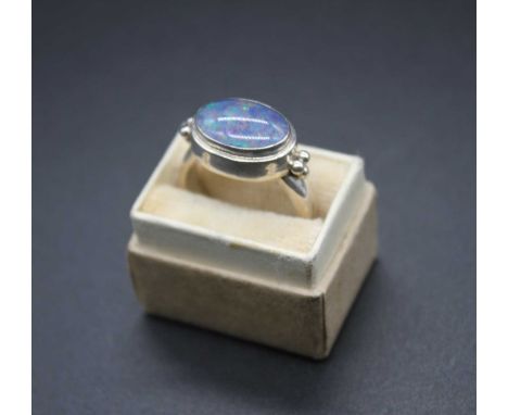 A modern white metal and cabochon opal set dress ring, stamped 925, 7.2g, size O