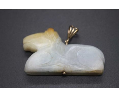 A Chinese carved pale celadon and russet jade pendant of a recumbent creature, 37.3g, 5.5cm