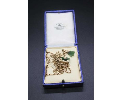 A 9ct gold cross pendant on finelink neck chain; together with a 9ct gold necklace with two jade pendants, gross weight 10.8g