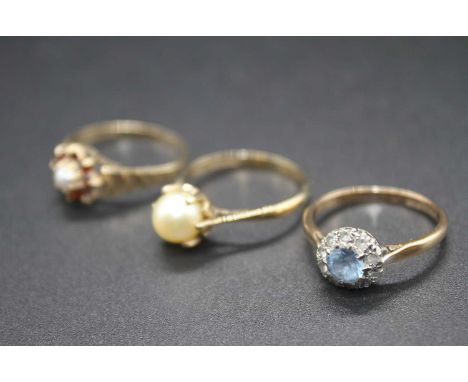 A modern 9ct gold, garnet and seed pearl set dress ring; together with a 9ct gold, blue topaz and cz set dress ring; and a 9c