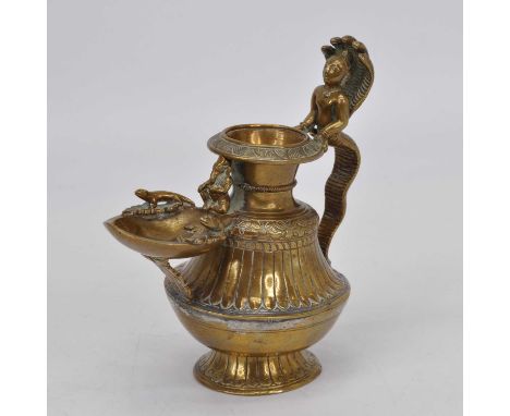 A Nepalese gilt copper oil lamp, having figural handle, height 15cm