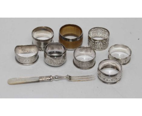 An early C20th horn and white metal mounted napkin ring, together with seven other silver napkin rings and a mother of pearl 