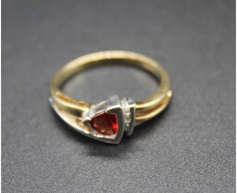 A modern 9ct gold, ruby (probably heat-treated) and three small diamond set ring, 3.2g, size N