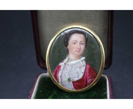 A French painted enamel portrait miniature of a woman wearing a pink dress, within yellow metal mount (cracked), 43 x 38mm