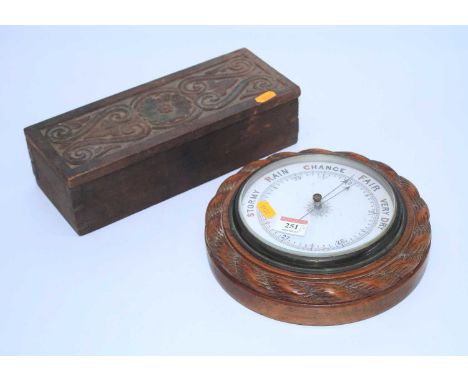 An early 20th century carved oak wall aneroid barometer, dia,. 23cm, together with a carved box