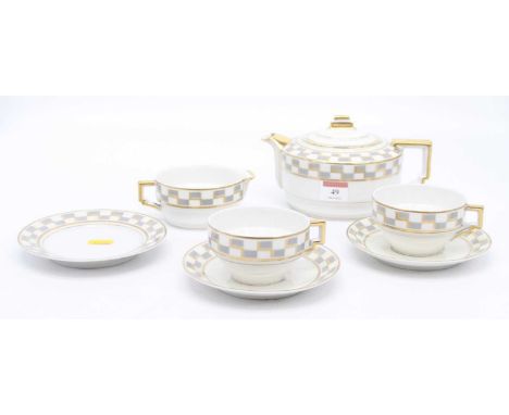 A Limoges Art Deco style part teaset with geometric decoration, comprising teapot, milk jug, side plate, two cups and two sau