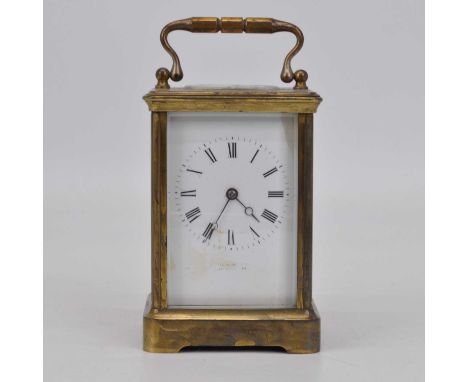 An early 20th century brass cased carriage clock, the enamel dial showing Roman numerals, and signed indistinctly having plat