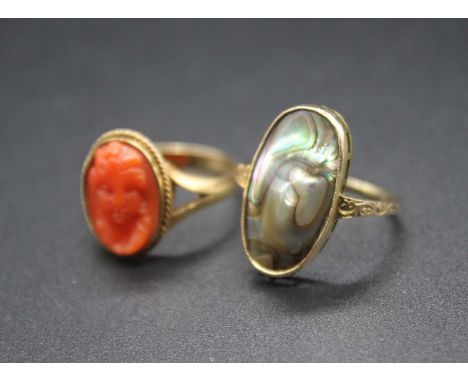 An 18ct gold carved coral set ring, 3.9g, size P; together with a yellow metal mother of pearl set dress ring (2)