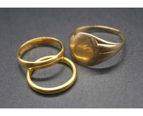Two 22ct gold wedding bands, undecorated, gross weight 6.6g; together with a 9ct gold gent's signet ring (cut), 3.9g (3)