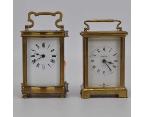 An early 20th century brass cased carriage clock, the enamel dial showing Roman numerals, height 12cm, together with another 