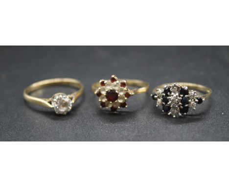 A 9ct gold, garnet and cz set flower head cluster ring; together with a 9ct gold, sapphire and diamond point dress ring; and 