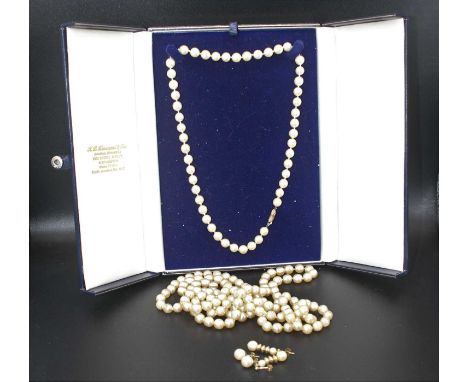 A cultured pearl knotted single string necklace, with 9ct gold clasp, circa 2000; together with a faux pearl single string ne