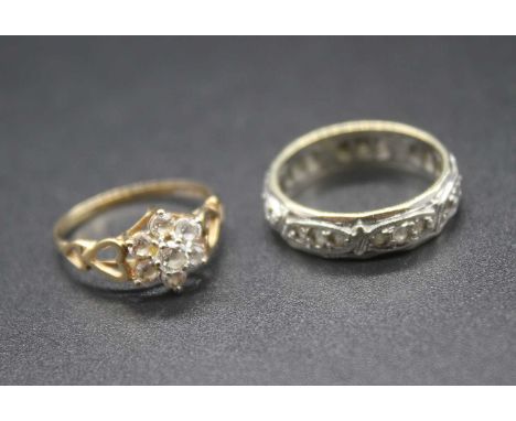 A 9ct gold and cz flower head cluster ring, size K; together with a 9ct gold and cz set eternity ring, gross weight 4.9g (2)