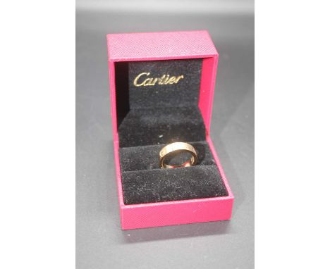 After Cartier - a gilt metal and paste set 'Love' ring, size MThis is rose gold.