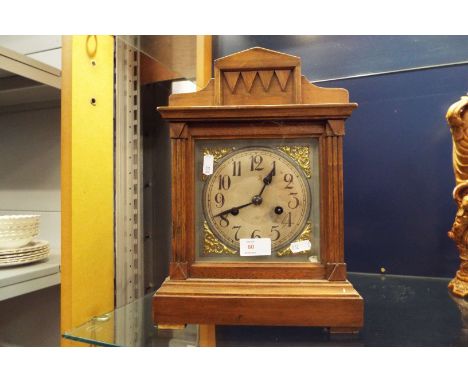 An oak framed mantel clock