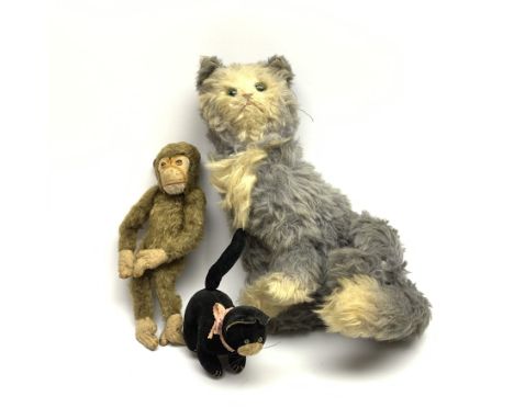 Steiff 'Fluffy' cat c1920s/30s in white and blue/grey mohair seated with tail curled around back legs, the swivelling head wi