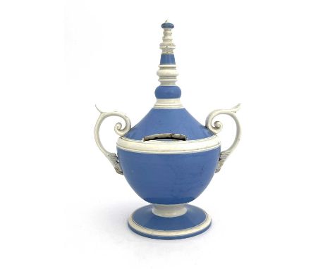 A pearlware twin handled money box, circa 1800, pedestal urn form glazed in blue and white, with bobbin turned conical finial