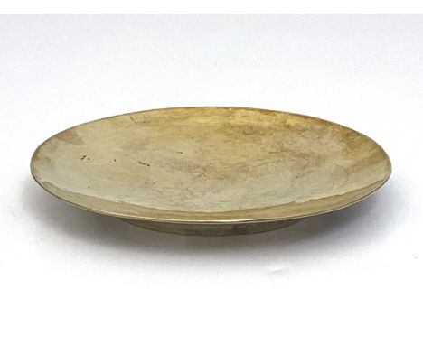 Guild of Handicraft, an Arts and Crafts silver and parcel gilt paten, London 1952, circular shallow dished form, cast in reli