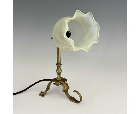 An Arts and Crafts brass Pullman type lamp, with vaseline glass shade, three foliate legs, one with hook fitting, adjustable 