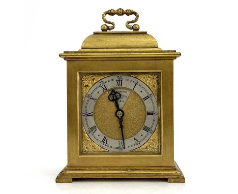 Goldsmiths &amp; Silversmiths, London, a 20th Century boudoir timepiece, brushed brass case in the form of a miniature bracke