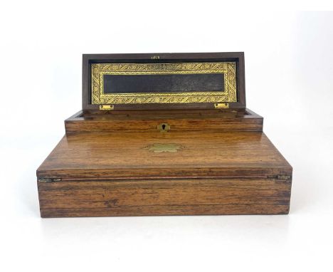 A Regency rosewood writing compendium, circa 1820, brass inlaid, caddy top with a concealed velvet lined compartment, flush b