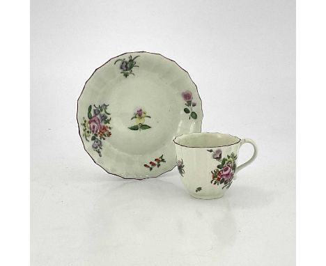 A Worcester polychrome fluted coffee cup and saucer, circa 1770, painted with floral sprigs and bouquets, red line borders, 1