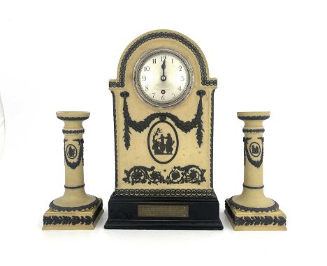 A Wedgwood tri colour Jasperware clock garniture set, yellow ground, domed bracket form with black relief moulded swags, scro