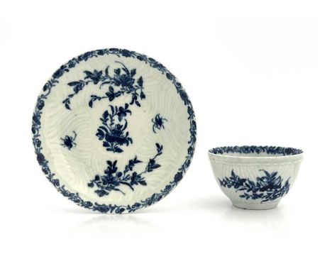 A Worcester blue and white tea bowl and saucer, workmans marks, circa 1757, in the Feather Mould Floral pattern, 11.5cm diame