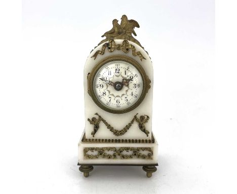 A French boudoir timepiece, circa 1900, arched white marble and ormolu mounted case incorporating lovebird's finial, trophies