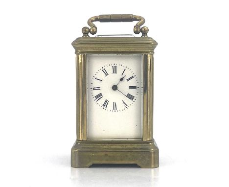 A miniature carriage timepiece, early 20th Century, brass corniche case with visible escapement, white enamel dial with Roman