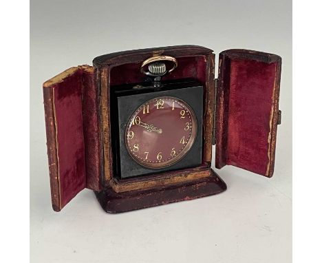 A chiming miniature desk or travel clock, circa 1910, anodised steel case with topwind mechanism, red guilloche enamel dial w