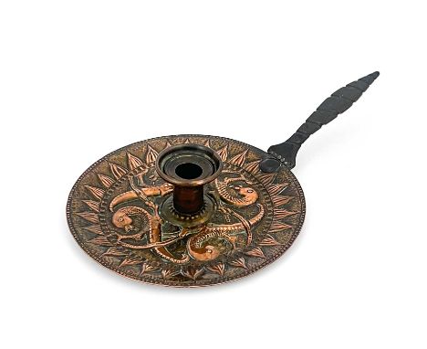 John Pearson, an Arts and Crafts copper chamberstick, 1896, the circular tray repousse embossed with Celtic style interlockin